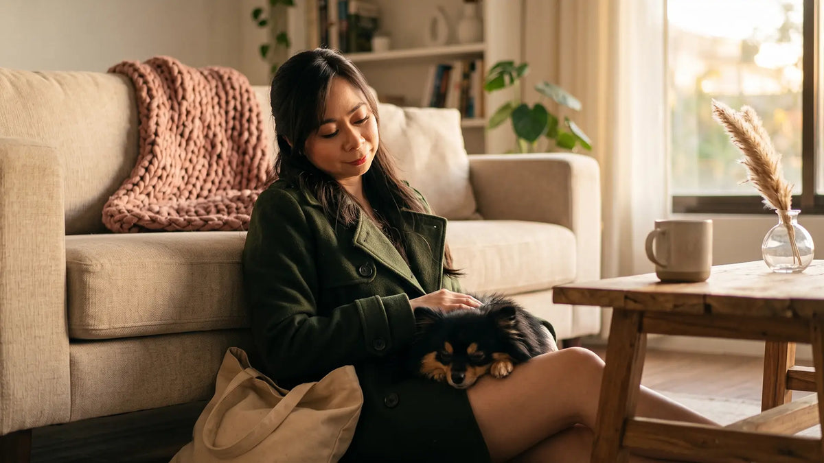 Tired woman home from a heavy day with her small dog, absorbing other people's emotions