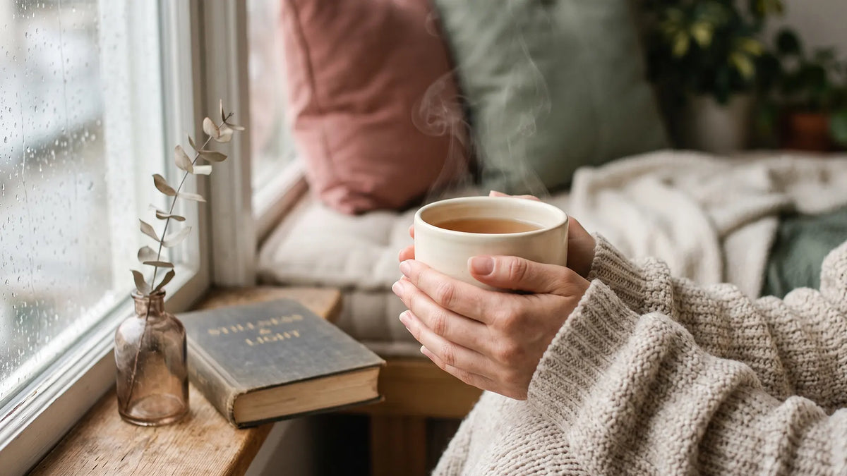 Hands cradling a warm mug by a rainy window, a quiet pause and gentle HSP boundaries