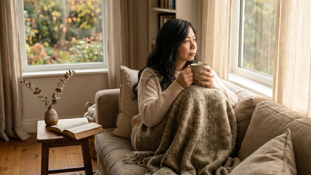 Woman enjoying introvert solitude with warm tea by a sunlit window